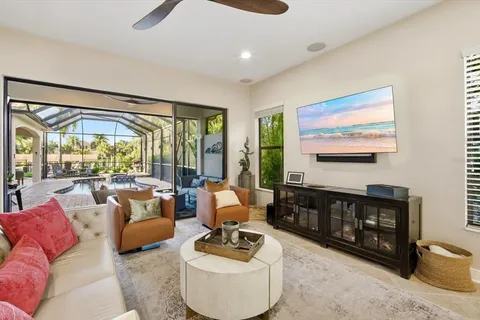 a living room with furniture and a floor to ceiling window