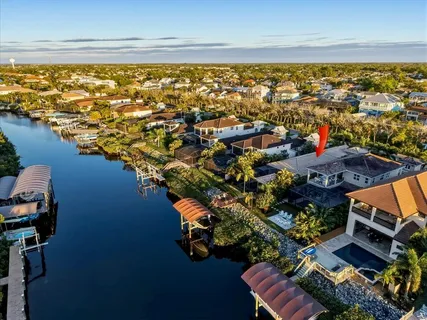 an aerial view of residential houses with outdoor space and ocean view