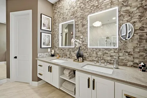 a bathroom with a double vanity sink and a mirror