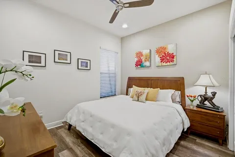 a bedroom with a bed and a lamp on table
