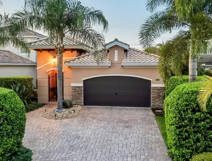 a front view of a house with a yard and a garage