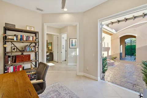 a view of a livingroom with workspace and a window