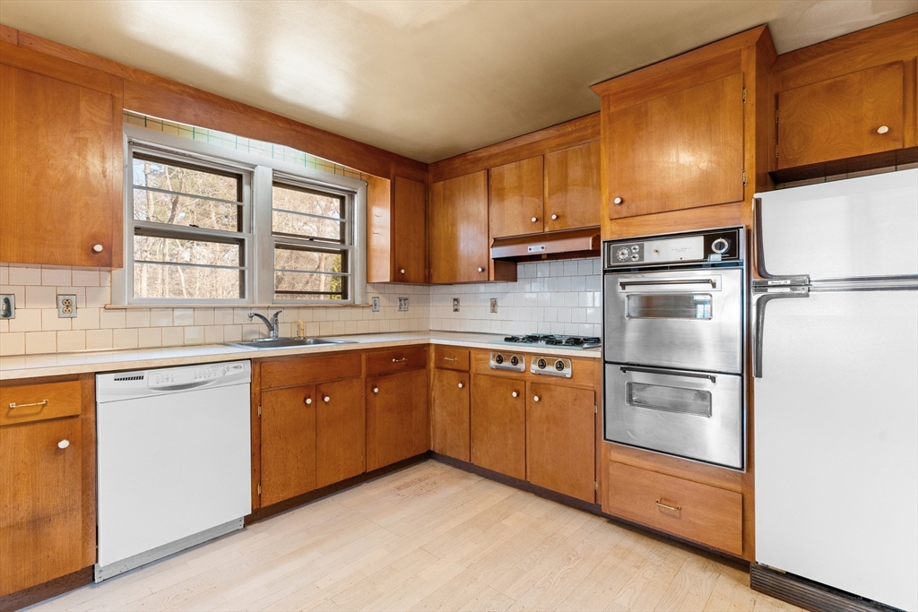 20 Joyce Road Framingham, MA 01701 - Photo 11 of 42 a kitchen with granite countertop stainless steel appliances a sink window and cabinets