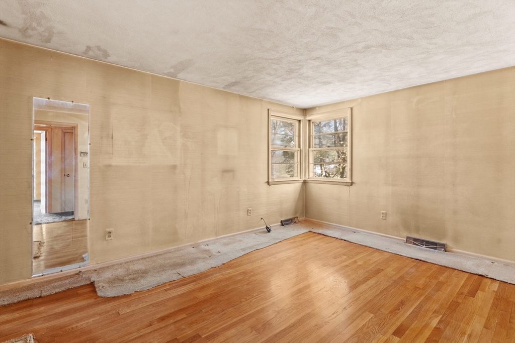 20 Joyce Road Framingham, MA 01701 - Photo 16 of 42 an empty room with wooden floor and windows