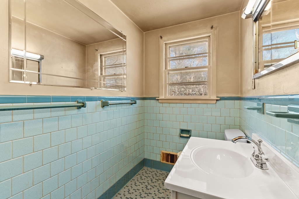 20 Joyce Road Framingham, MA 01701 - Photo 22 of 42 a bathroom with a sink a toilet and a mirror
