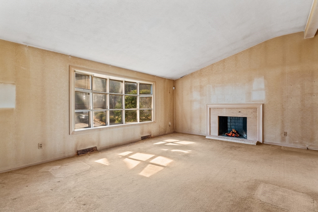 20 Joyce Road Framingham, MA 01701 - Photo 5 of 42 an empty room with a fireplace and window