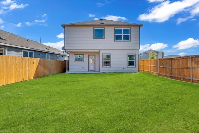 a view of a house with backyard and garden