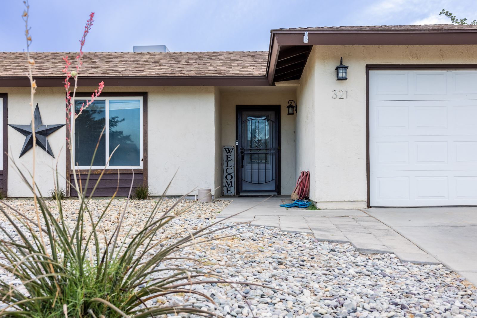 321 Mari Court Ridgecrest, CA 93555 - Photo 4 of 26 a view of a house with a wooden fence