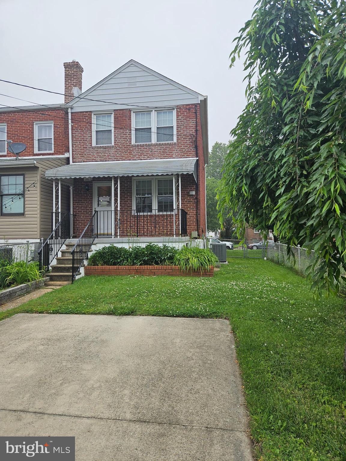 6907 Belclare Road Baltimore, MD 21222 - Photo 19 of 26 a front view of a house with a yard