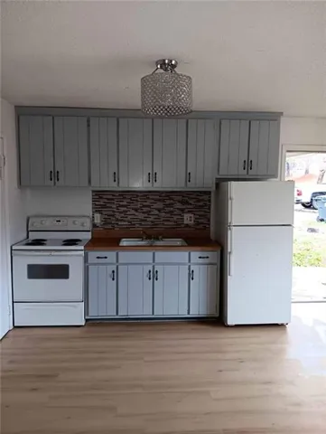 a kitchen with wooden cabinets and white appliances