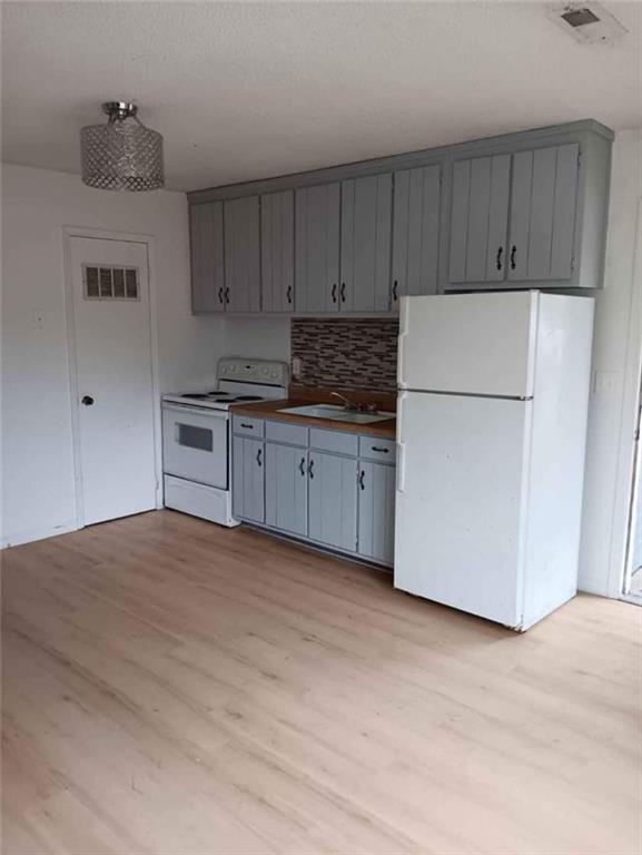 480 Cason Road Cedartown, GA 30125 - Photo 2 of 10 a kitchen with granite countertop a refrigerator and a stove top oven