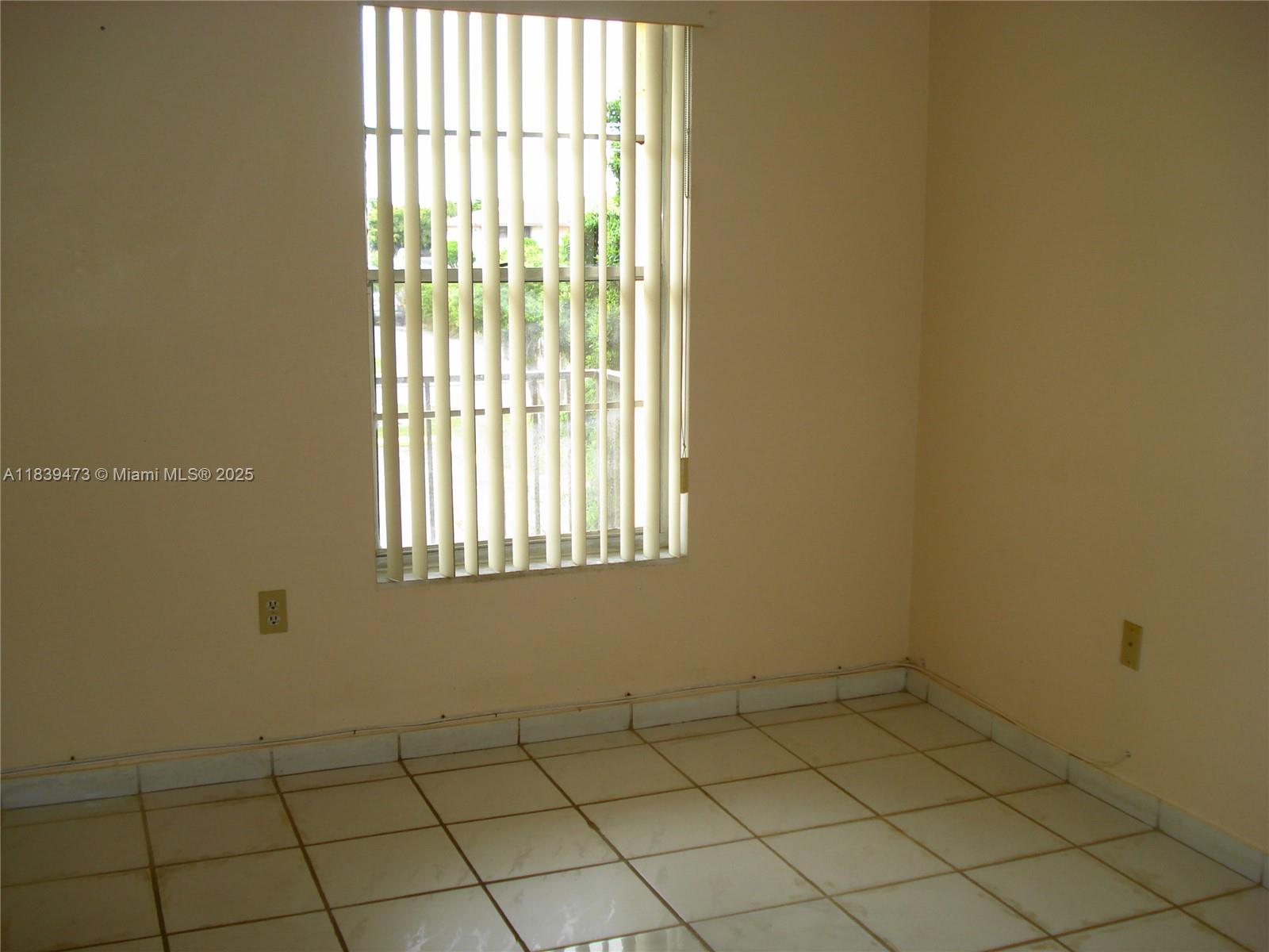 5755 West 20th Avenue, Unit 206 Hialeah, FL 33012 - Photo 11 of 23 an empty room and window