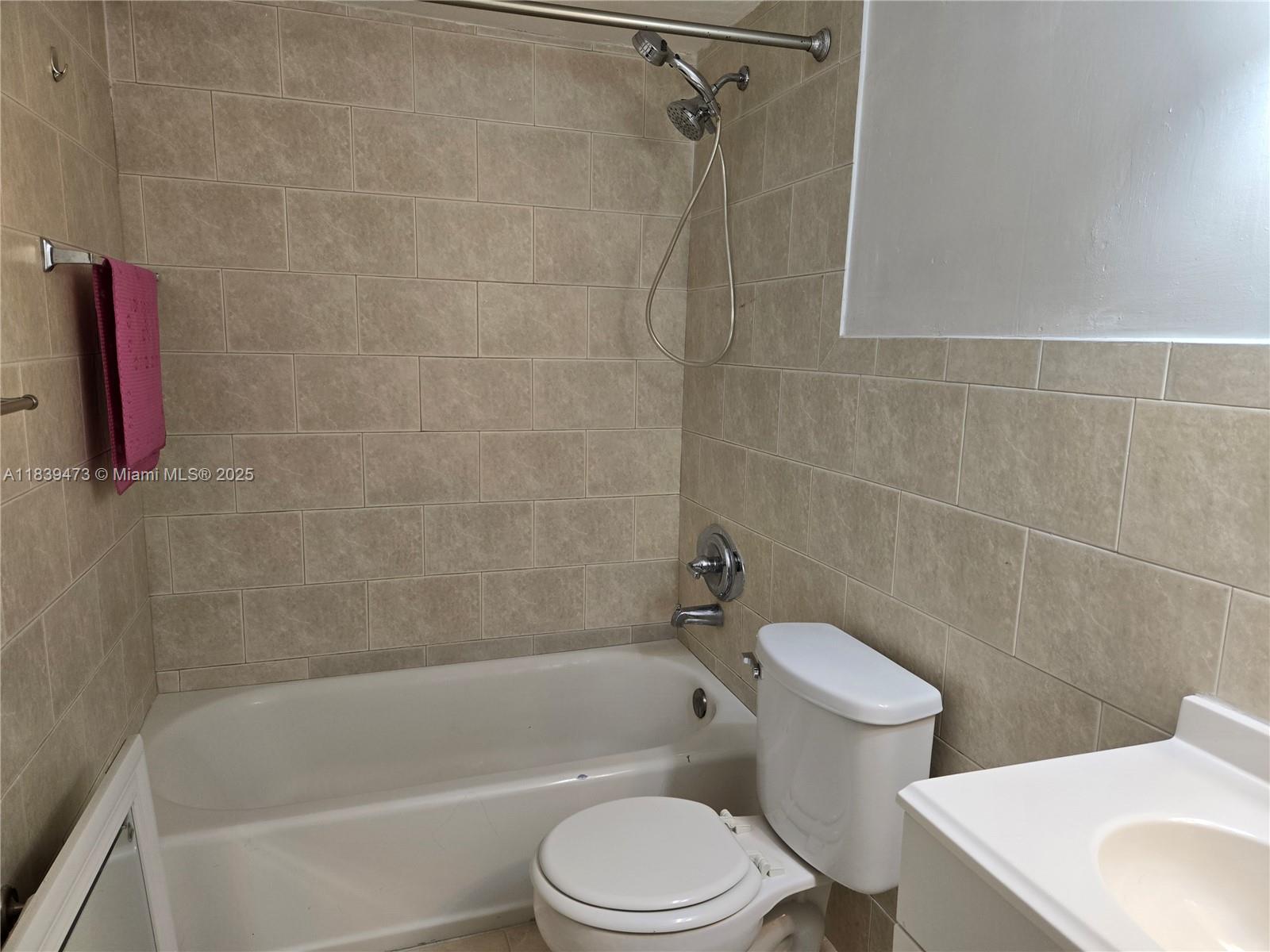 5755 West 20th Avenue, Unit 206 Hialeah, FL 33012 - Photo 12 of 23 a white bath tub sitting next to a white toilet
