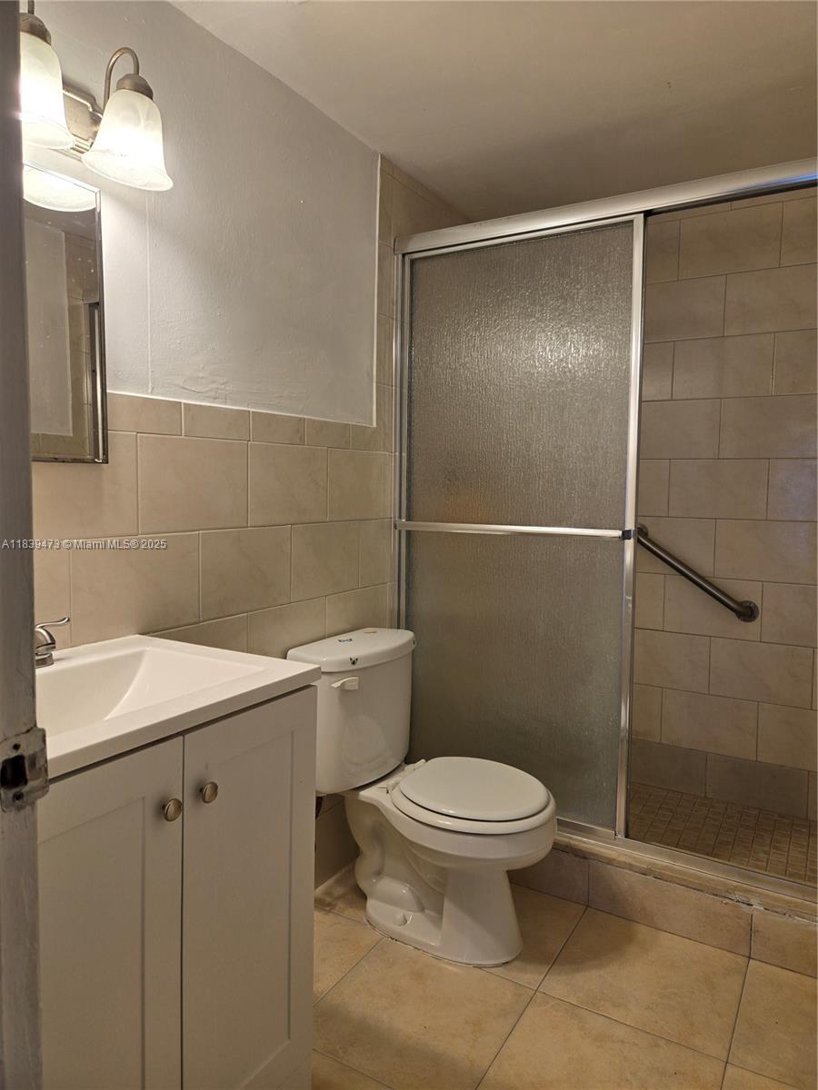 5755 West 20th Avenue, Unit 206 Hialeah, FL 33012 - Photo 13 of 23 a bathroom with a sink a toilet and shower