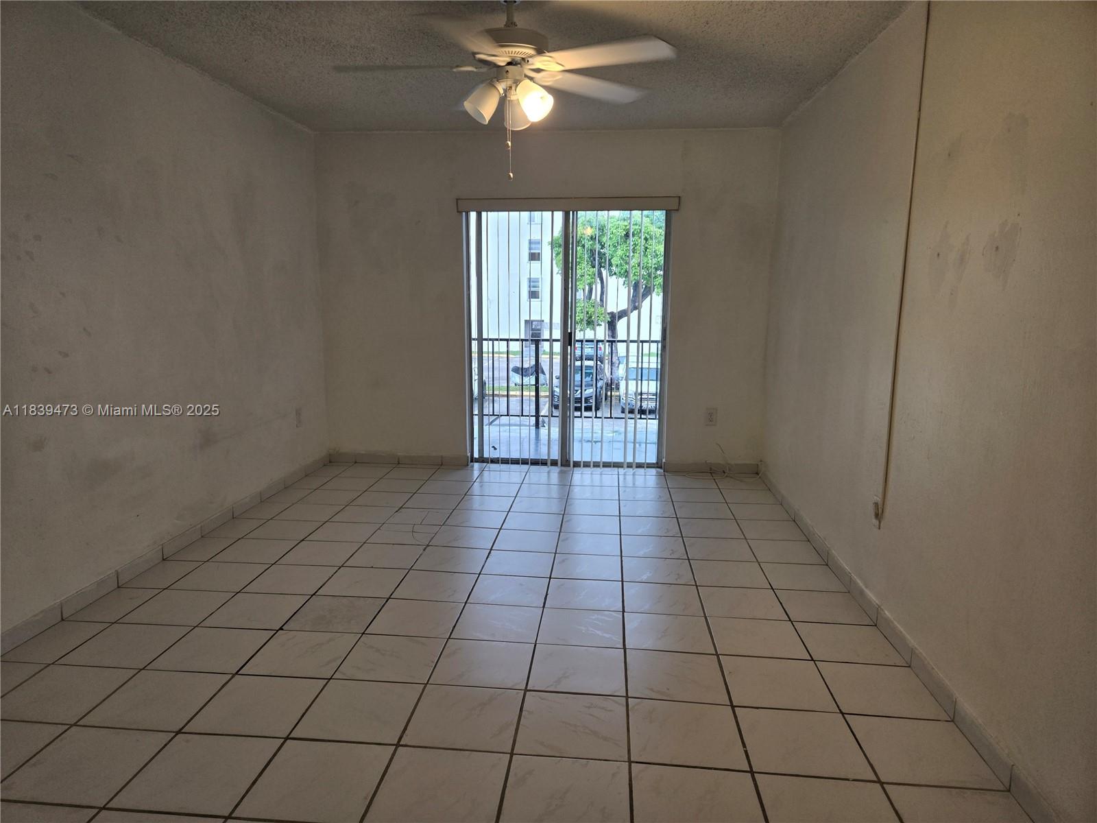 5755 West 20th Avenue, Unit 206 Hialeah, FL 33012 - Photo 2 of 23 a view of an empty room and window
