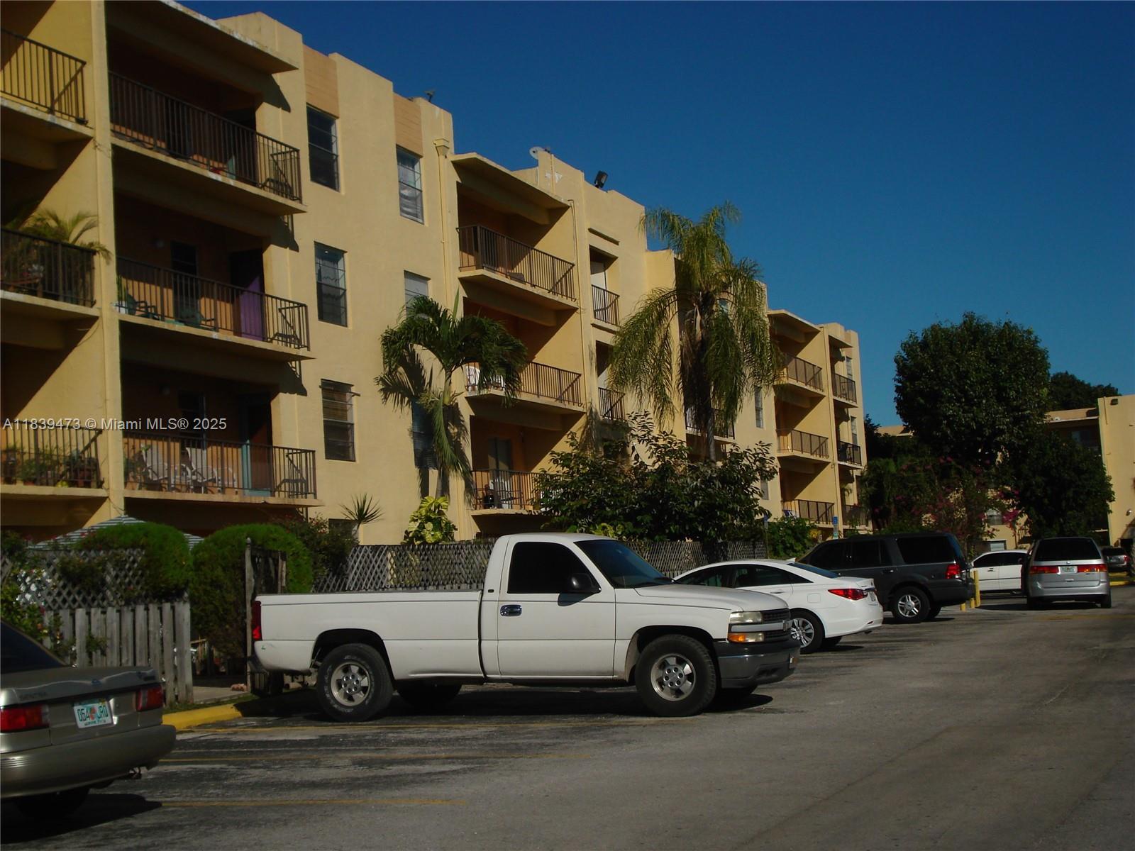 5755 West 20th Avenue, Unit 206 Hialeah, FL 33012 - Photo 21 of 23 a view of street with parked cars