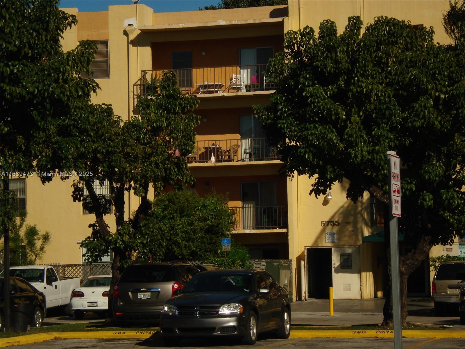 5755 West 20th Avenue, Unit 206 Hialeah, FL 33012 - Photo 22 of 23 a view of street with parked cars