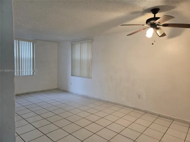 a view of an empty room and wooden floor