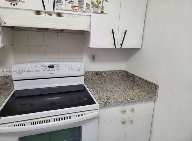 a kitchen with a sink and washing machine