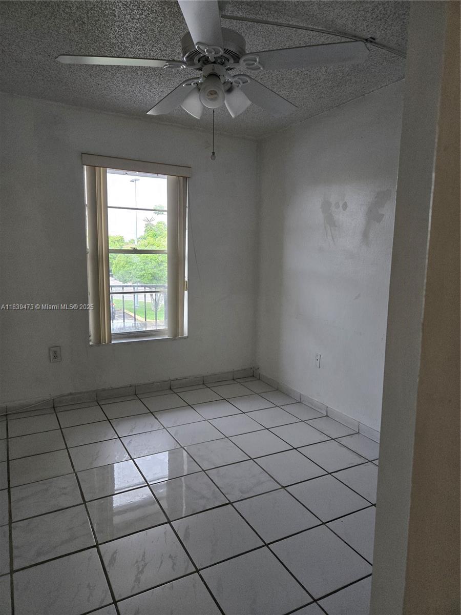 5755 West 20th Avenue, Unit 206 Hialeah, FL 33012 - Photo 10 of 23 a view of an empty room with a window