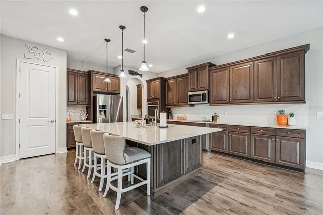 a living room with furniture wooden floor and a view of kitchen