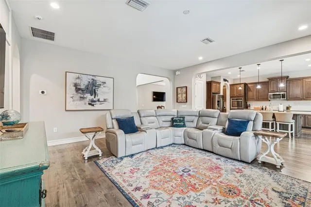 a spacious bathroom with a granite countertop sink a mirror and a shower