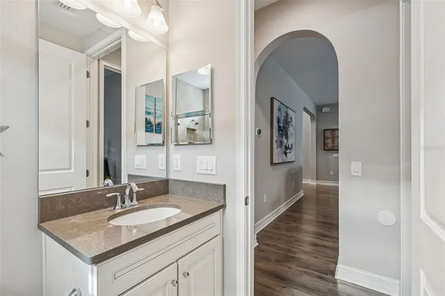 a spacious bedroom with a bed and a flat screen tv