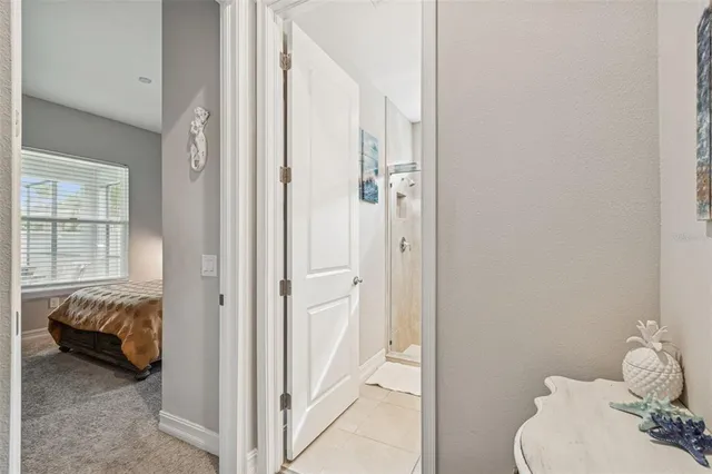 a view of a hallway with wooden floor and glass door