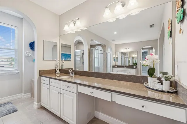 a bathroom with double vanity sinks and a mirror