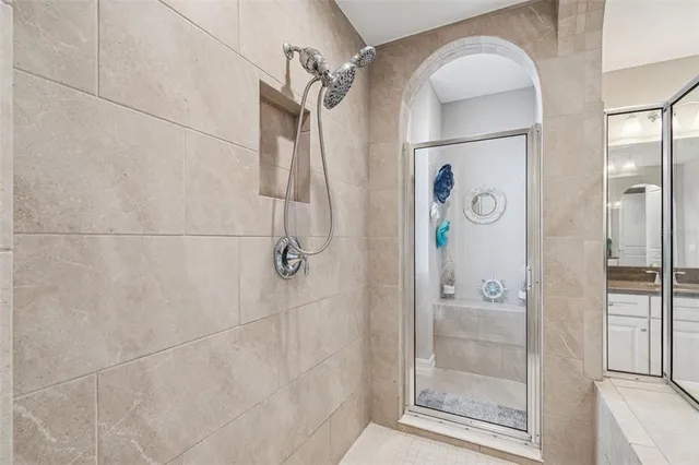 a view of a livingroom with an empty space & a window