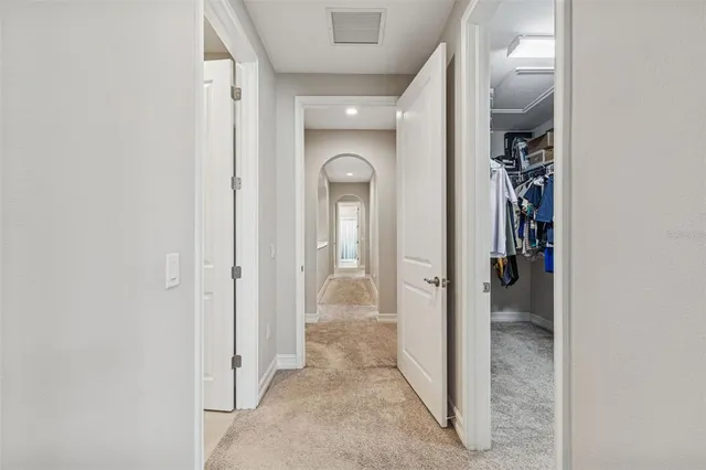 an aerial view of residential houses with outdoor space and lake view
