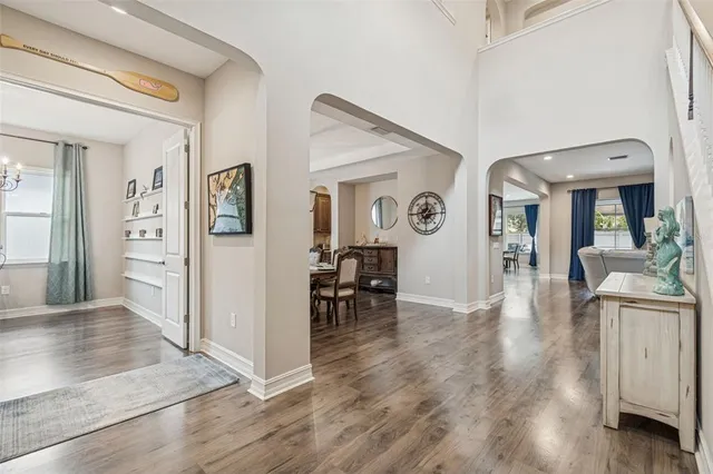 a view of a dining room with furniture a chandelier and wooden floor