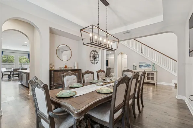 a large kitchen with kitchen island a island a sink a counter space appliances and cabinets