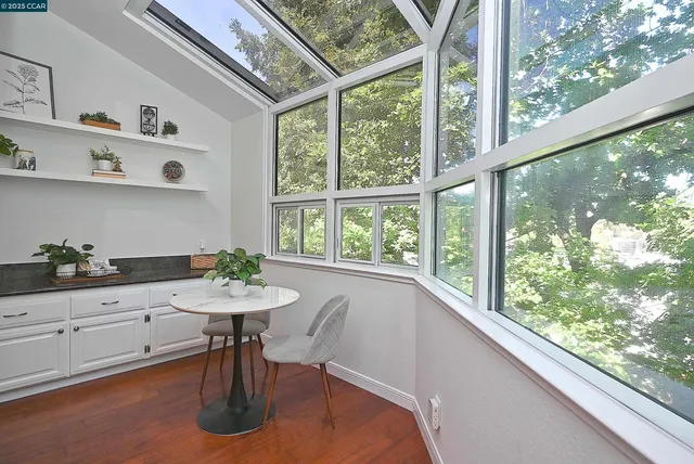 a kitchen with a sink a table and chairs