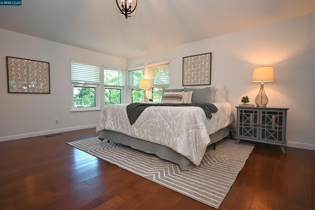 a living room with a bed furniture and a window