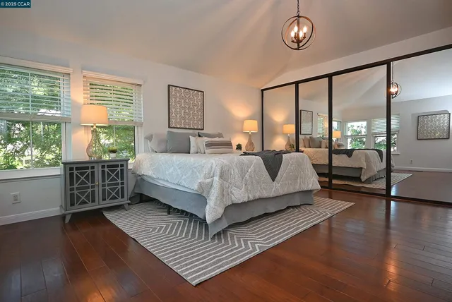 a bedroom with a large bed and a large window