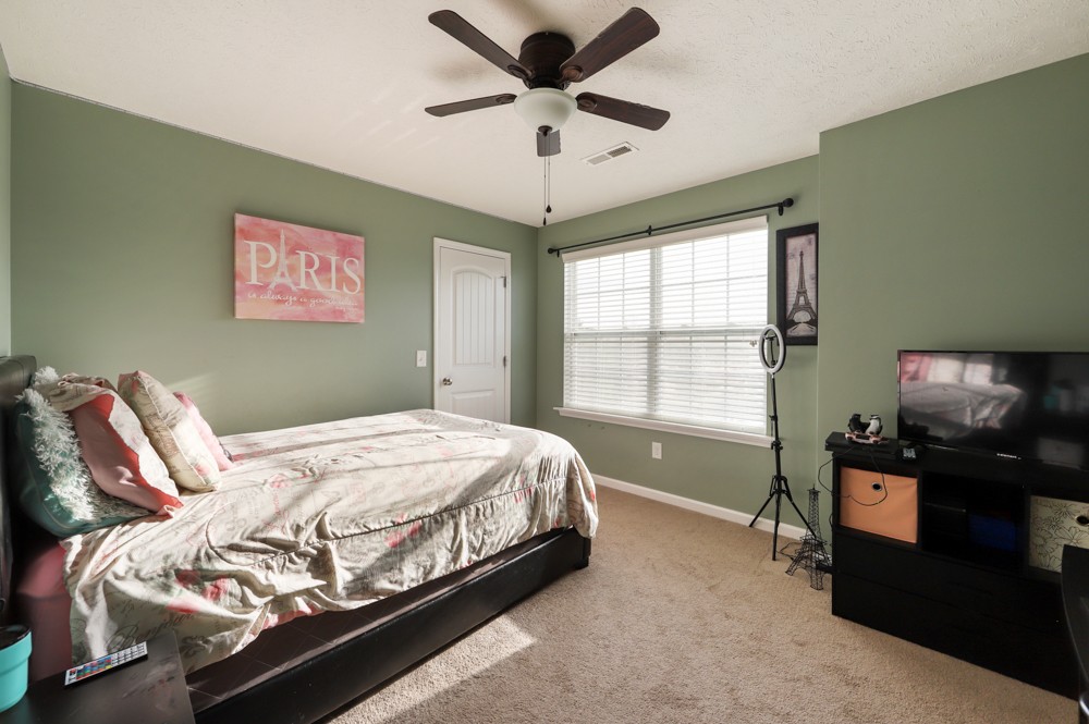 1080 Woodall Road Lebanon, TN 37090 - Photo 14 of 24 a bedroom with a bed and a chandelier