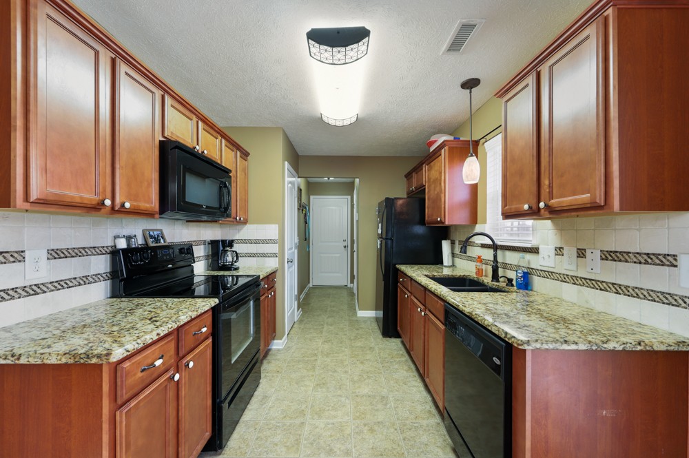 1080 Woodall Road Lebanon, TN 37090 - Photo 7 of 24 a large kitchen with stainless steel appliances granite countertop a stove a sink dishwasher and a refrigerator