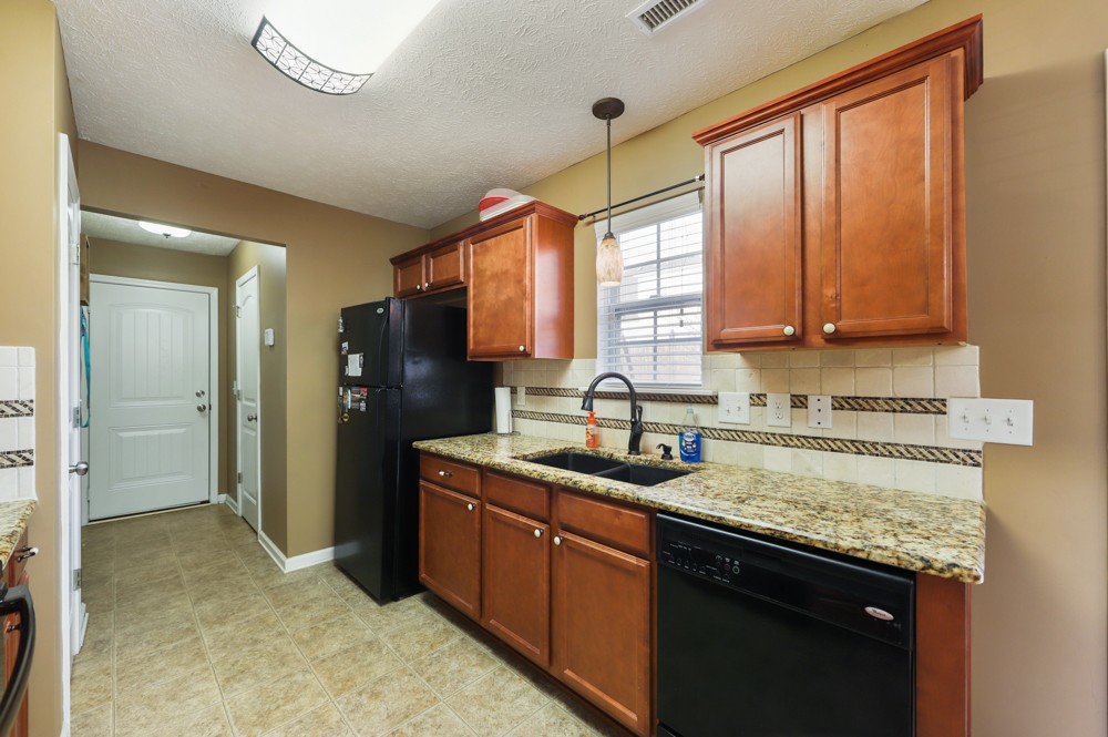 1080 Woodall Road Lebanon, TN 37090 - Photo 8 of 24 a kitchen with stainless steel appliances granite countertop a sink a stove and a refrigerator