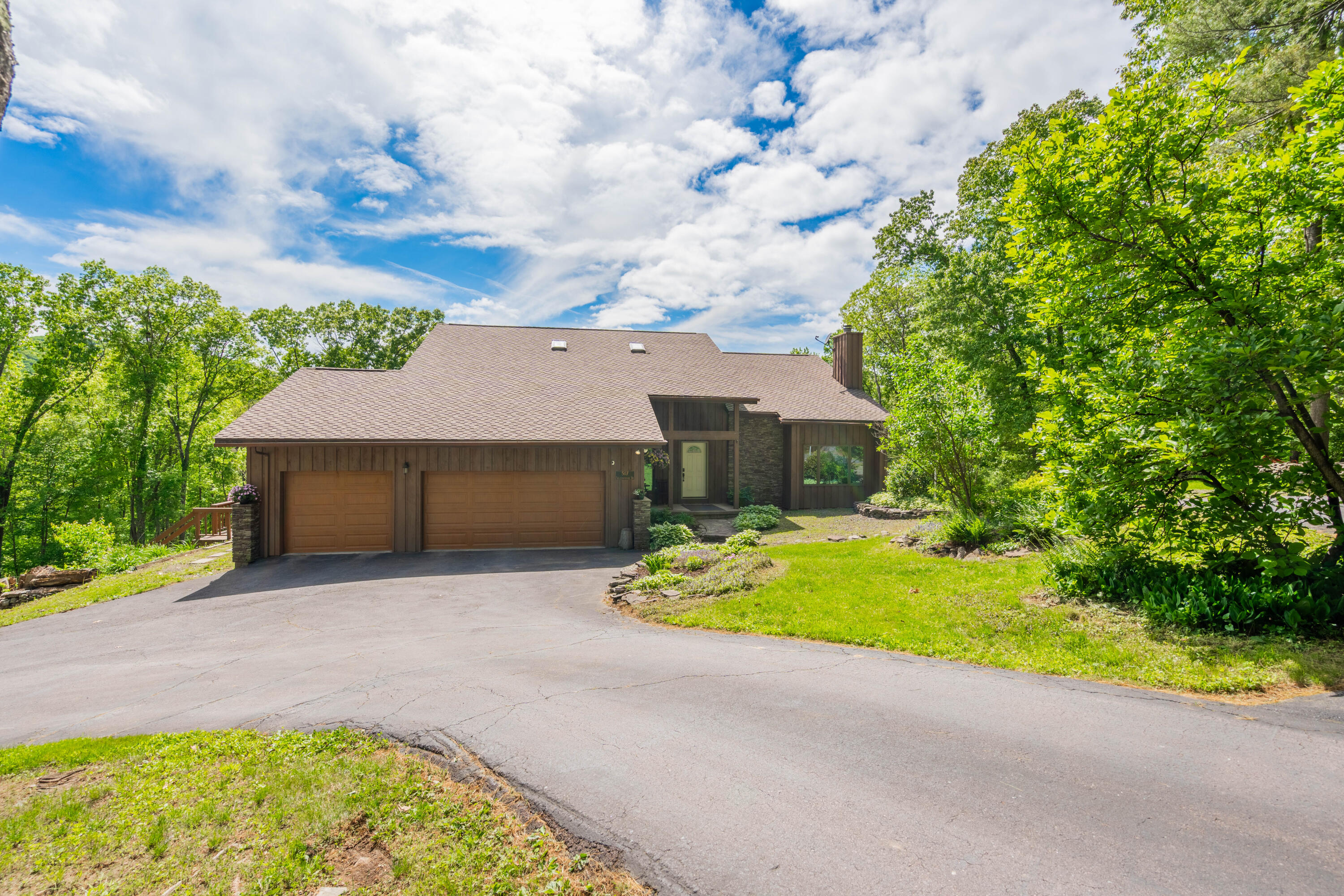 507 Shadowbrook Drive Tunkhannock, PA 18657 - Photo 3 of 57 a yellow house with trees in front of it