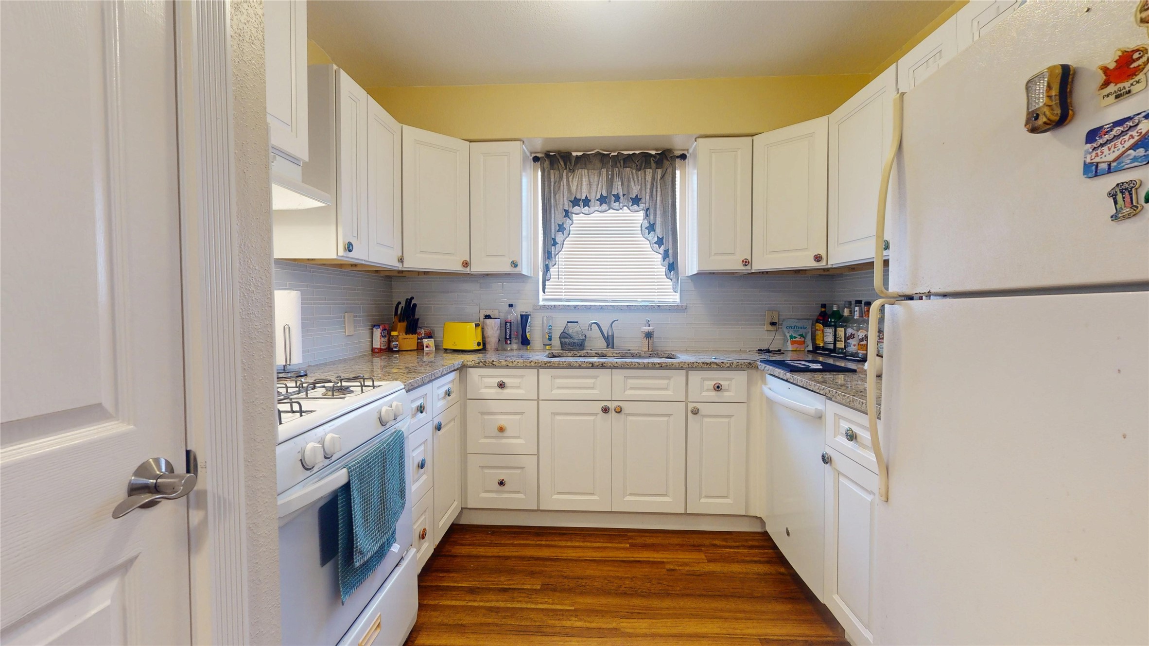 4713 Pine Street Pasadena, TX 77586 - Photo 15 of 38 a kitchen with stainless steel appliances granite countertop a refrigerator sink and white cabinets