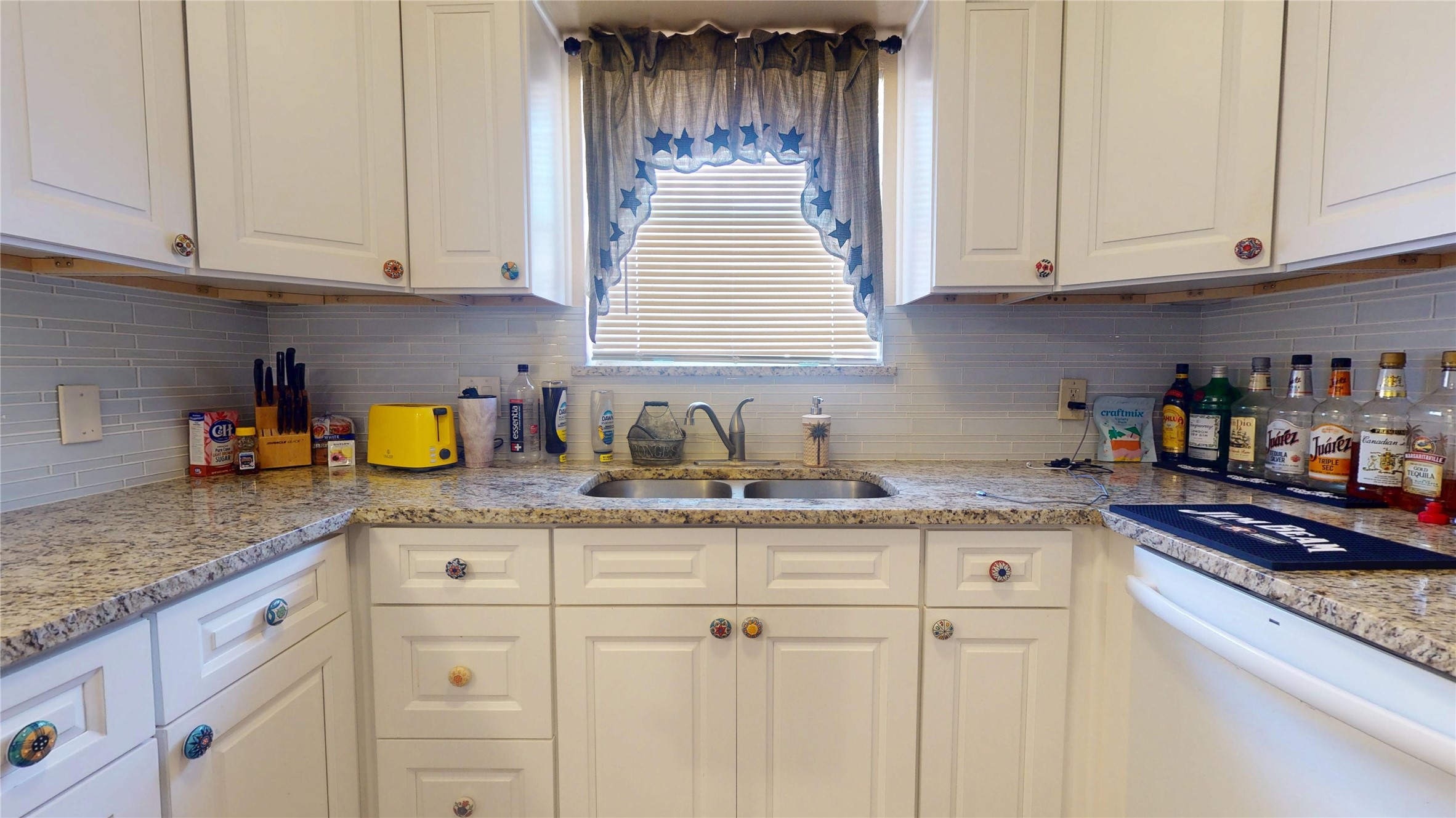 4713 Pine Street Pasadena, TX 77586 - Photo 16 of 38 a kitchen with granite countertop white cabinets and a sink