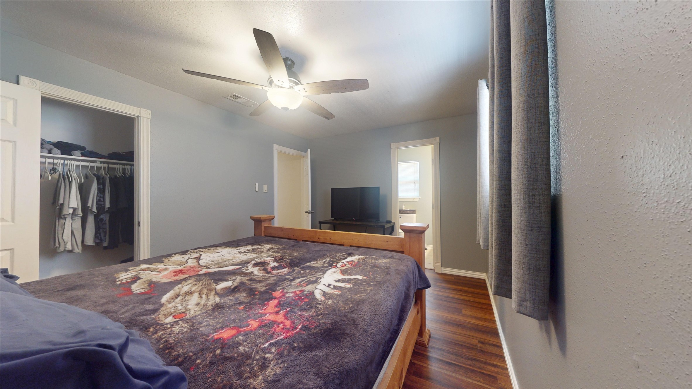 4713 Pine Street Pasadena, TX 77586 - Photo 32 of 38 a bedroom with a large bed and a chandelier