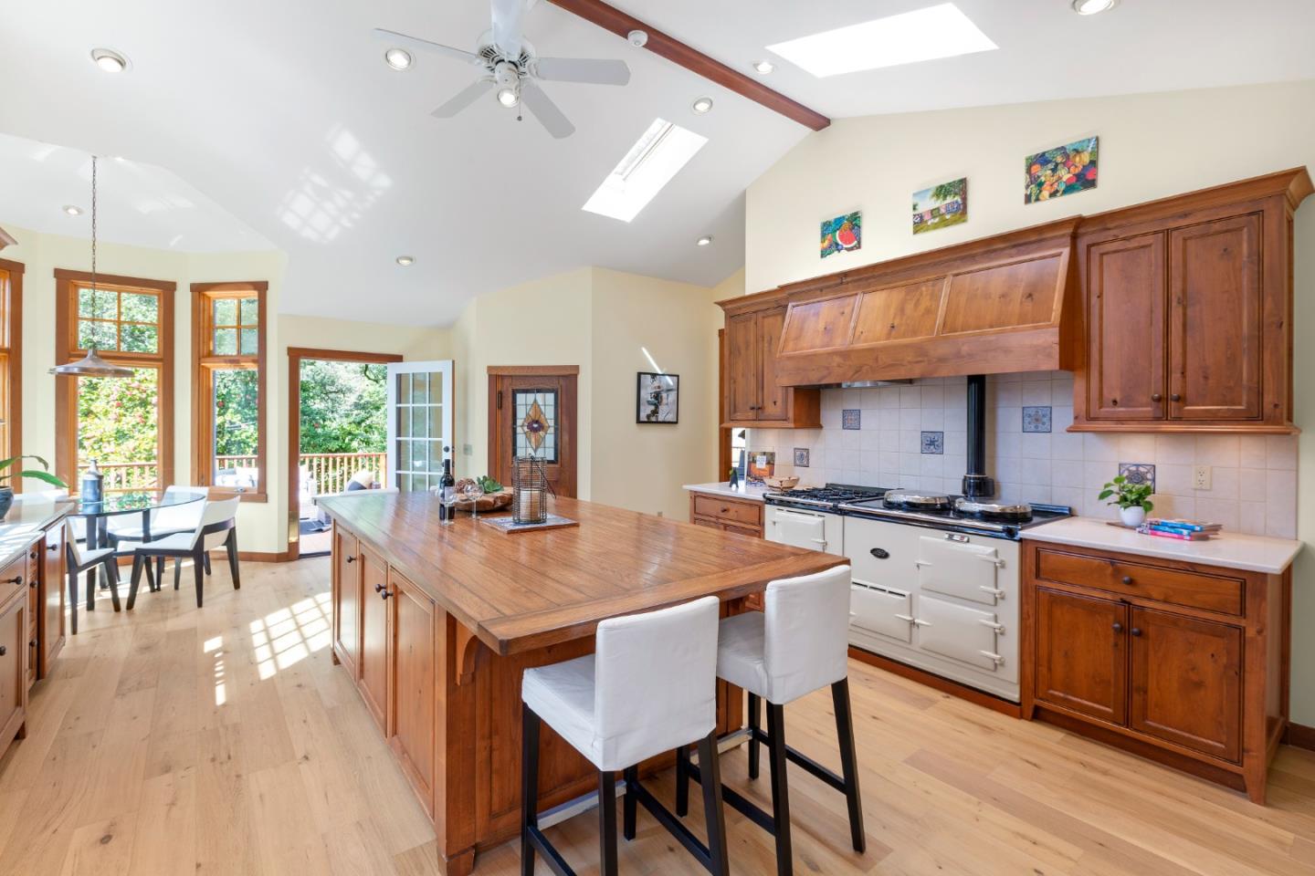 36 Skyline Drive Woodside, CA 94062 - Photo 18 of 67 a kitchen with stainless steel appliances granite countertop a stove top oven a sink dishwasher and white cabinets with wooden floor