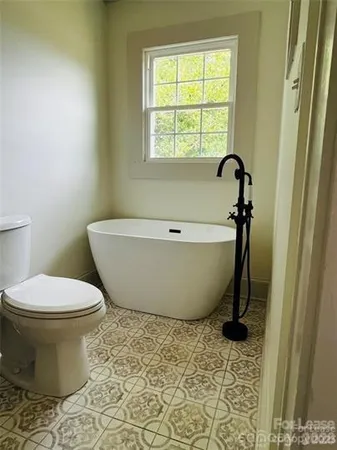 a bathroom with a toilet and a bathtub