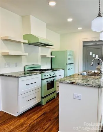 a kitchen with stainless steel appliances granite countertop a stove and a sink