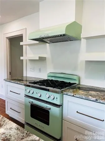 a white stove top oven sitting inside of a kitchen