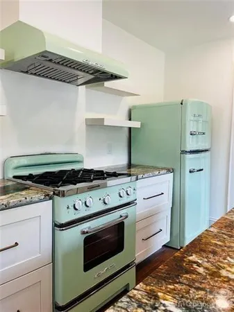 a kitchen with a stove and a cabinets