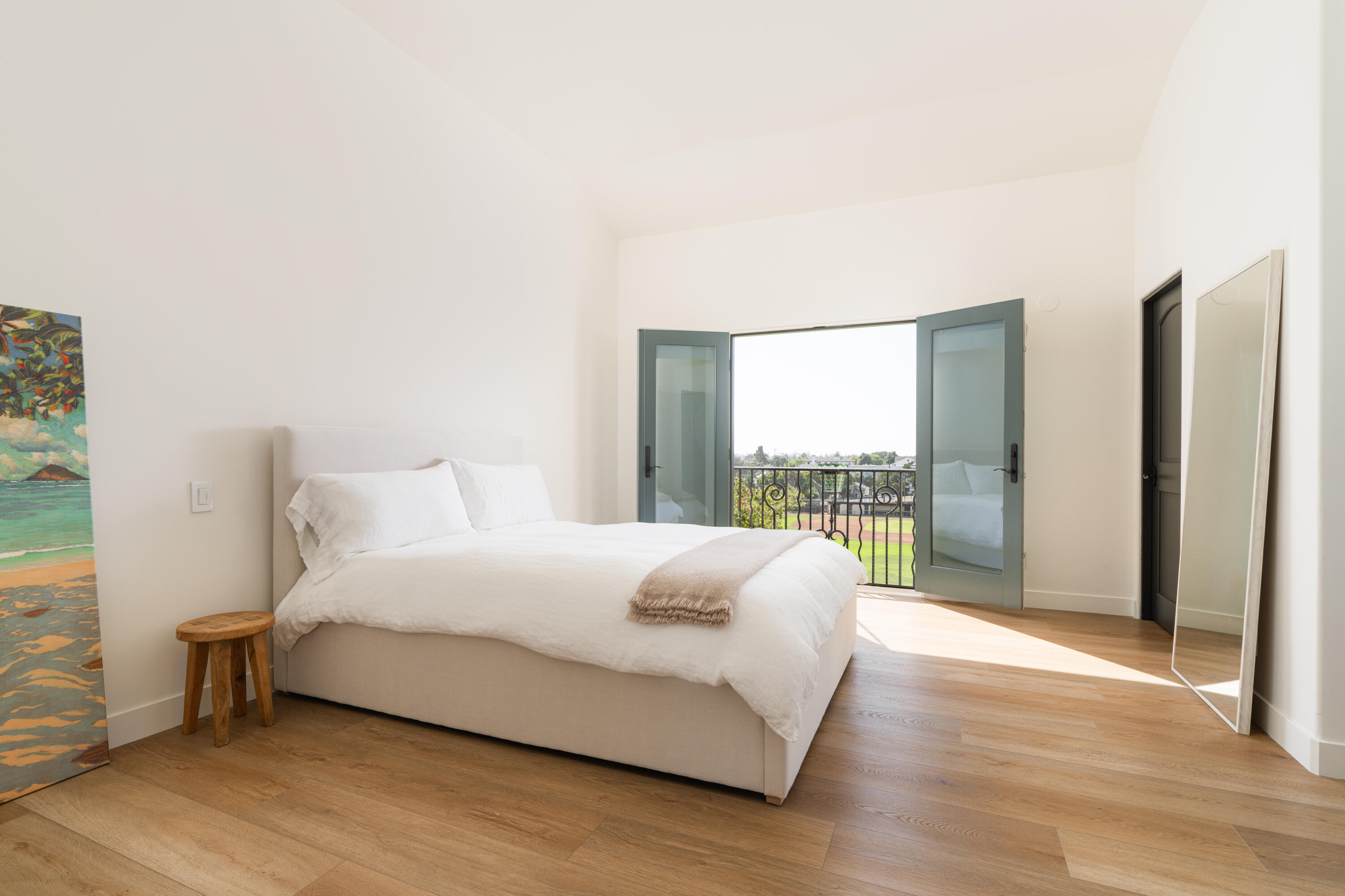 1011 Rinconada Road, Unit G Santa Barbara, CA 93101 - Photo 13 of 31 a bedroom with a bed lamp and a large window