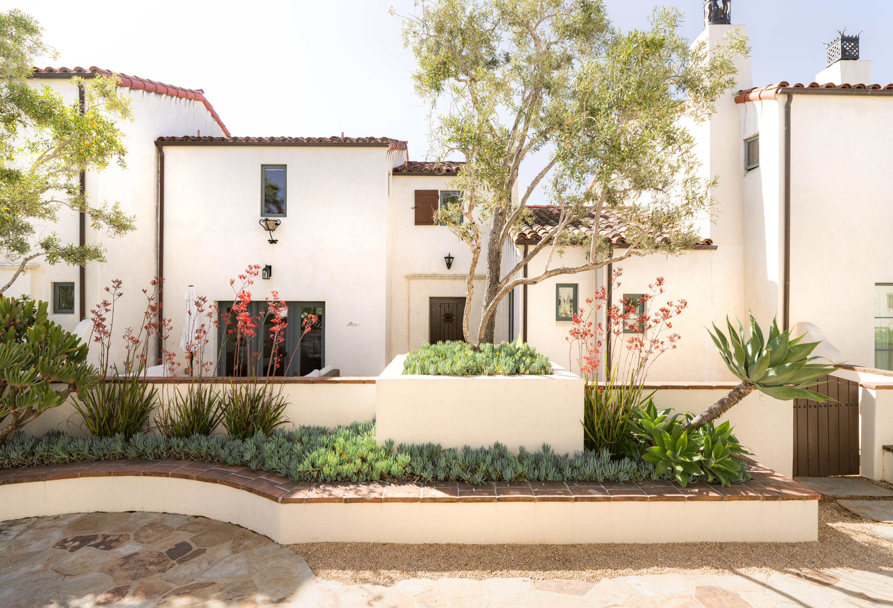 1011 Rinconada Road, Unit G Santa Barbara, CA 93101 - Photo 2 of 31 a front view of a house with a yard and potted plants
